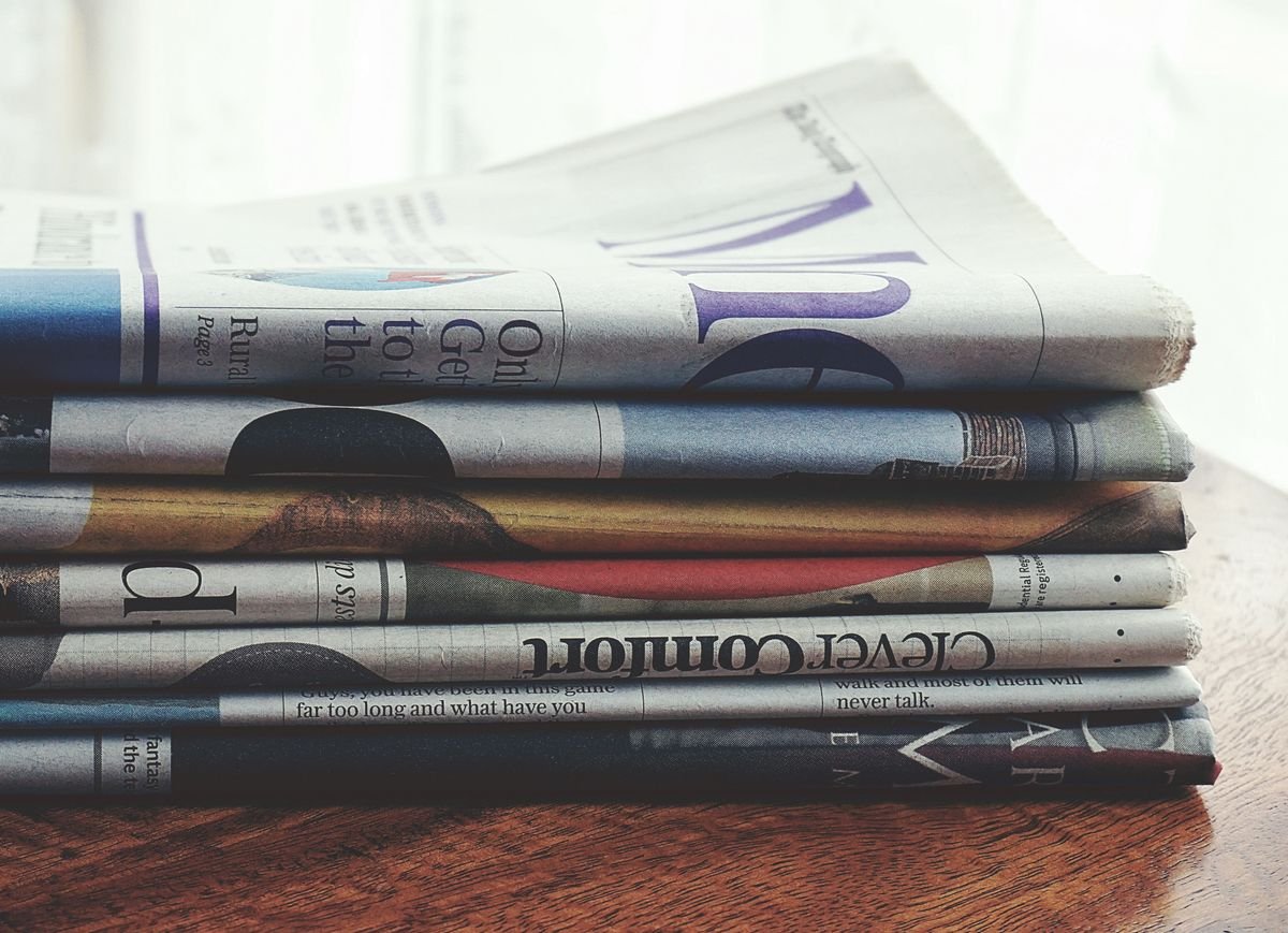 A stack of folded newspapers on a table