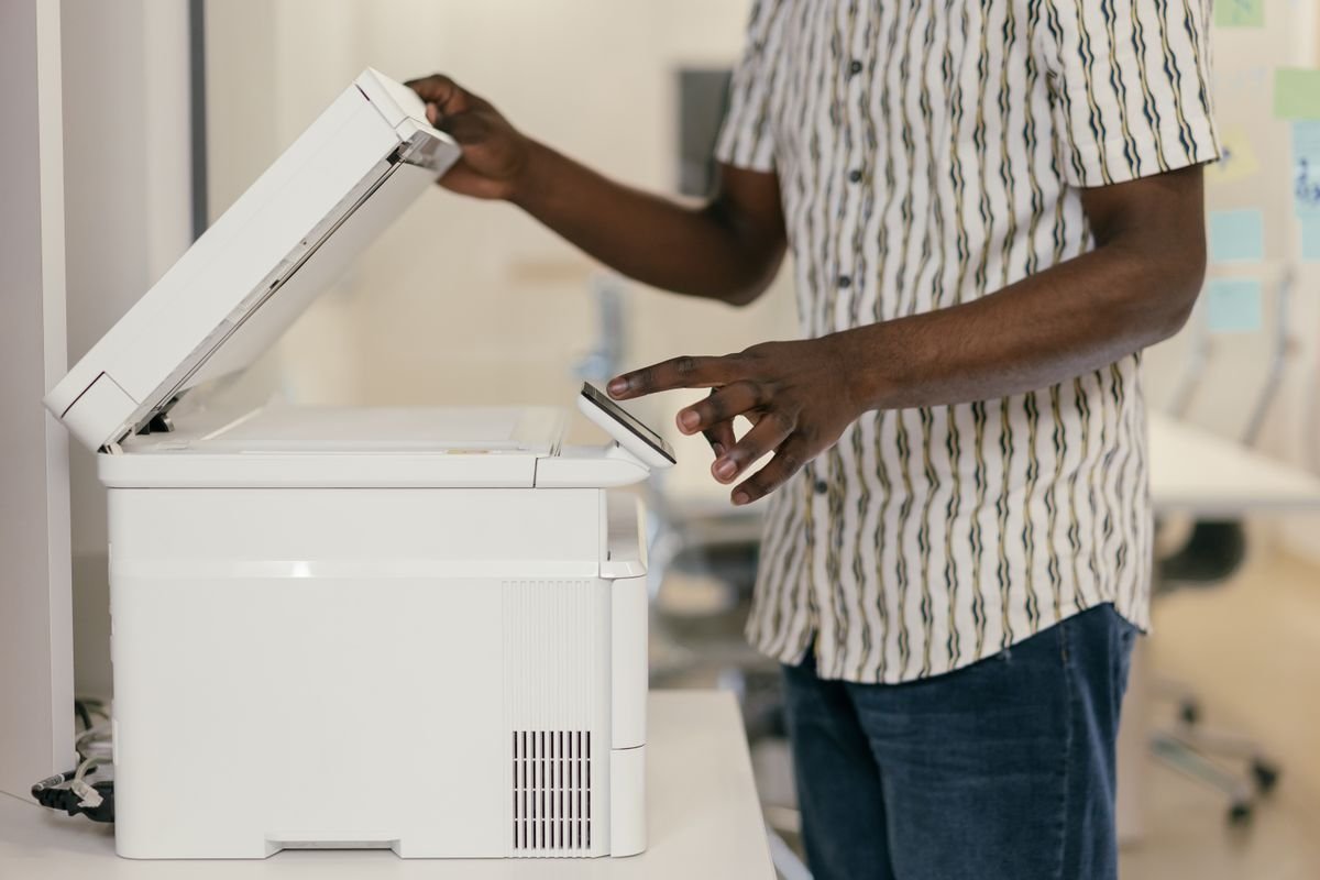 Someone placing a document on a photocopier
